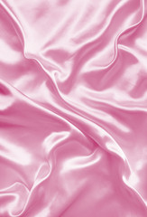 Smooth elegant pink silk or satin texture as background