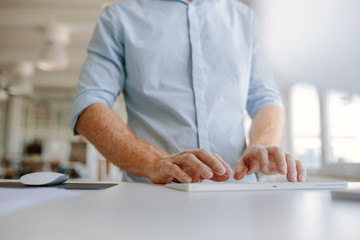 Businessman hands typing on computer keyboard