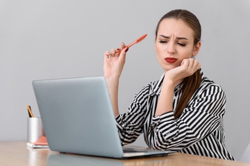 Young businesswoman working at desk in studio