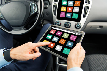 close up of man with tablet pc in car