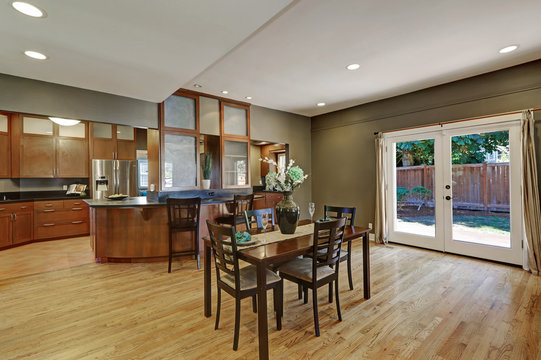 Spacious dining room with hardwood floor and exit to backyard