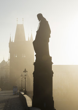 Foggy sunrise on Charles Bridge in Prague, Czech Republic