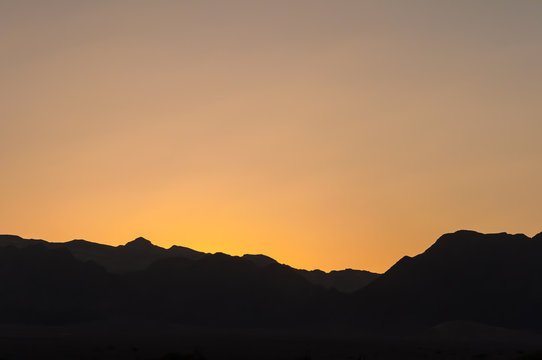 Sunset over mountain ridge in Negev desert, Israel with copy space for background design