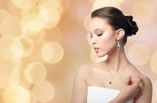 beautiful woman with jewelry over holidays lights