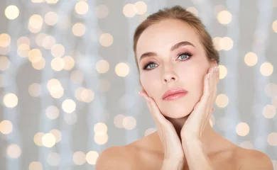 beautiful woman touching her face over lights
