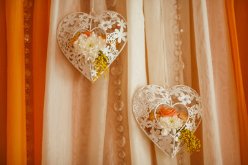 Decorative white hearts hang from orange tablecloth