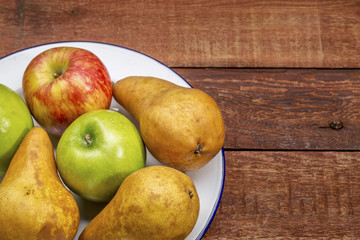 apples and pears on rustic wood table
