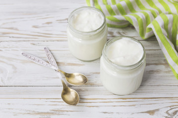 Obraz na płótnie Canvas Homemade yogurt in glass jar on wooden table.
