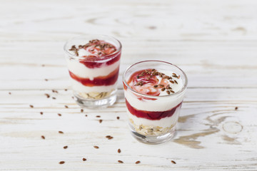 Homemade yogurt with berry jam, linseed and oat flakes