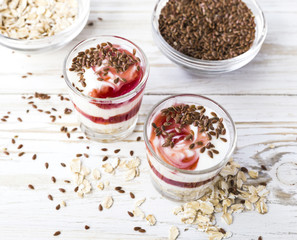 Homemade yogurt with berry jam, linseed and oat flakes