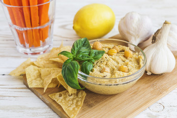 Fresh homemade organic hummus with pita cheaps and basil