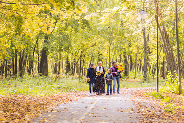 Happy young family spending time together outside in autumn nature.