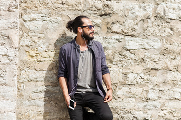 Obraz premium man with earphones and smartphone listening music