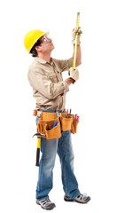 Full-length construction worker contractor carpenter in hard hat and tool belt measuring to ceiling isolated on white background