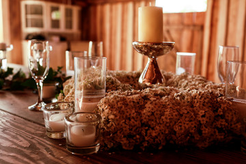Candleholder stands in the middle of white wreath
