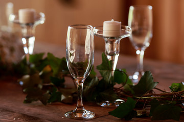 Green garland twines around empty glasses