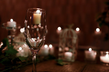 Glass sparkles in the lights of burning candles