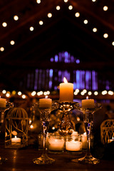 Dark storage decorated with candles in crystal vases