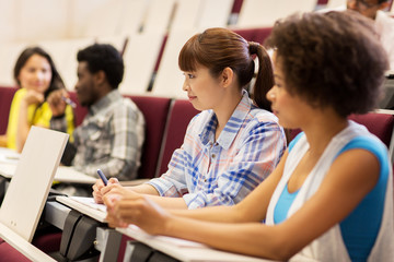group of students talking in lecture hall