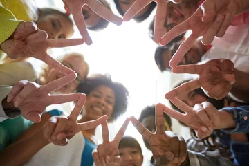 Fotobehang international students showing peace or v sign © Syda Productions