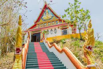 Naklejka premium Phuket, Thailand - April 25, 2016 : The main stair leading to the replica of Phra That In-Kwaen (Hanging Golden Rock) at Sirey temple, Phuket, Thailand.