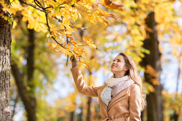 beautiful happy young woman walking in autumn park