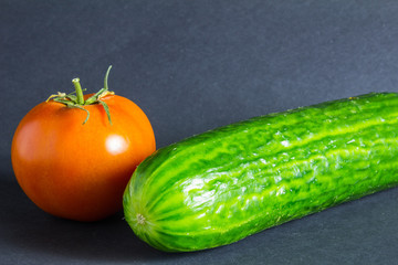 fresh vegetables tomato, cucumber on a dark background