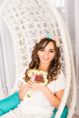 Stylish woman with flowers in a white interior