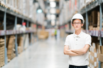 Handsome young Asian engineer or technician or worker, warehouse