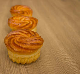 Muffins with cheese  on a wooden background