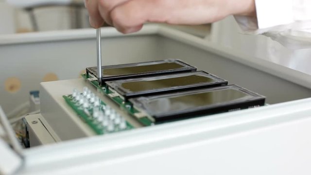 Engineer assembly electronic device, screw lcd displays with screwdriver in enclosure
