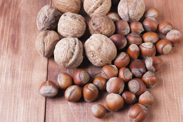 Mix of nuts on wooden background.
