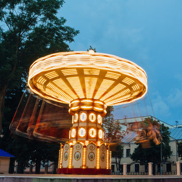A working carousel in the evening hours in the park