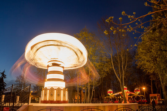 The rotating carousel in the park illuminated attractions