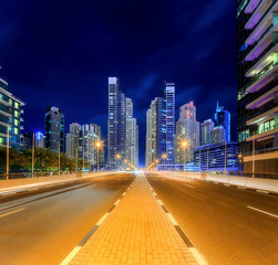 Fototapeta premium Panoramic view of Dubai Marina bay with yacht and cloudy sky, Dubai, UAE