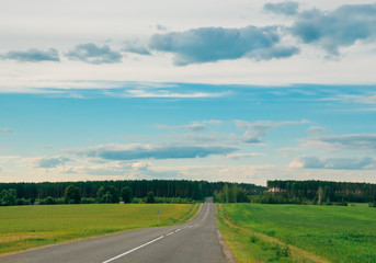 Fototapeta na wymiar Motorway in the rural areas of the forest and sky