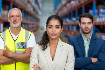 Portrait of warehouse team standing with arms crossed