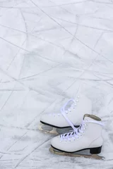 Foto op Plexiglas I love ice skating. Ice skates on rink background. © Gorilla