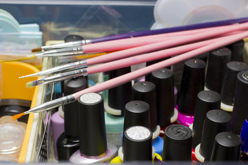 Set of different nail varnishes on shelves in cosmetic store