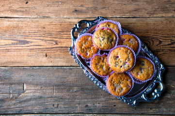 Tasty homemade muffins on silver tray. Top view. Copyspace