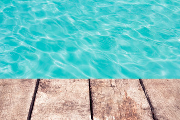 Obraz premium swimming pool with sunny reflections and wood floor