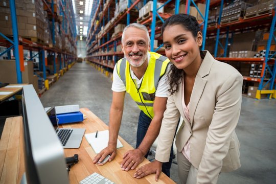 Portrait of warehouse manager and worker working together