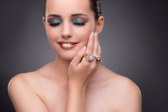 Beautiful woman showing off her jewellery in fashion concept