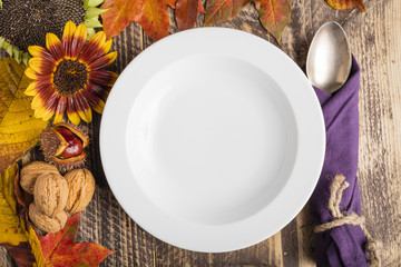 autumn fall decorated rustic wooden classy table white plate text space