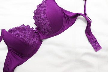 Top view of woman's  bra on the unmade bed