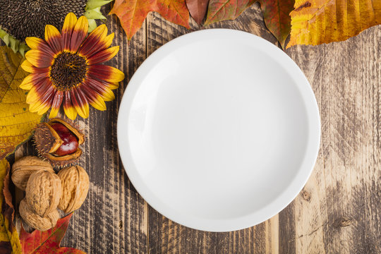 autumn fall decorated rustic wooden classy table white plate text space