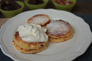 Russian sweet cheese pancakes with sour cream for Breakfast or a snack - it's delicious