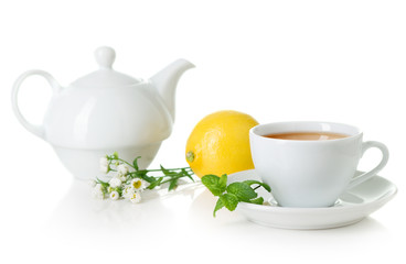 White teacup, teapot with herbal tea