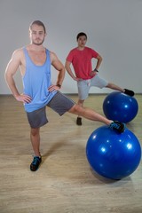 Fototapeta na wymiar Men exercising with exercise ball