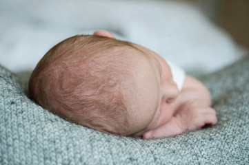 Unrecognizable newborn baby boy, close up